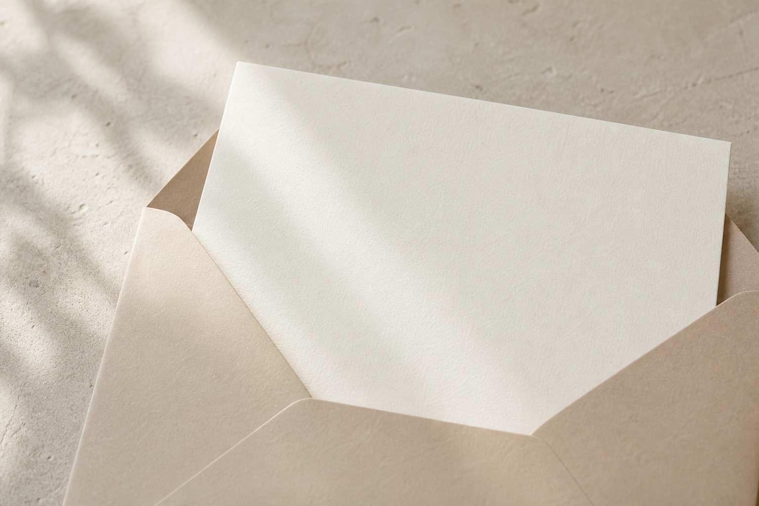 A blank handwritten note tucked into a beige envelope